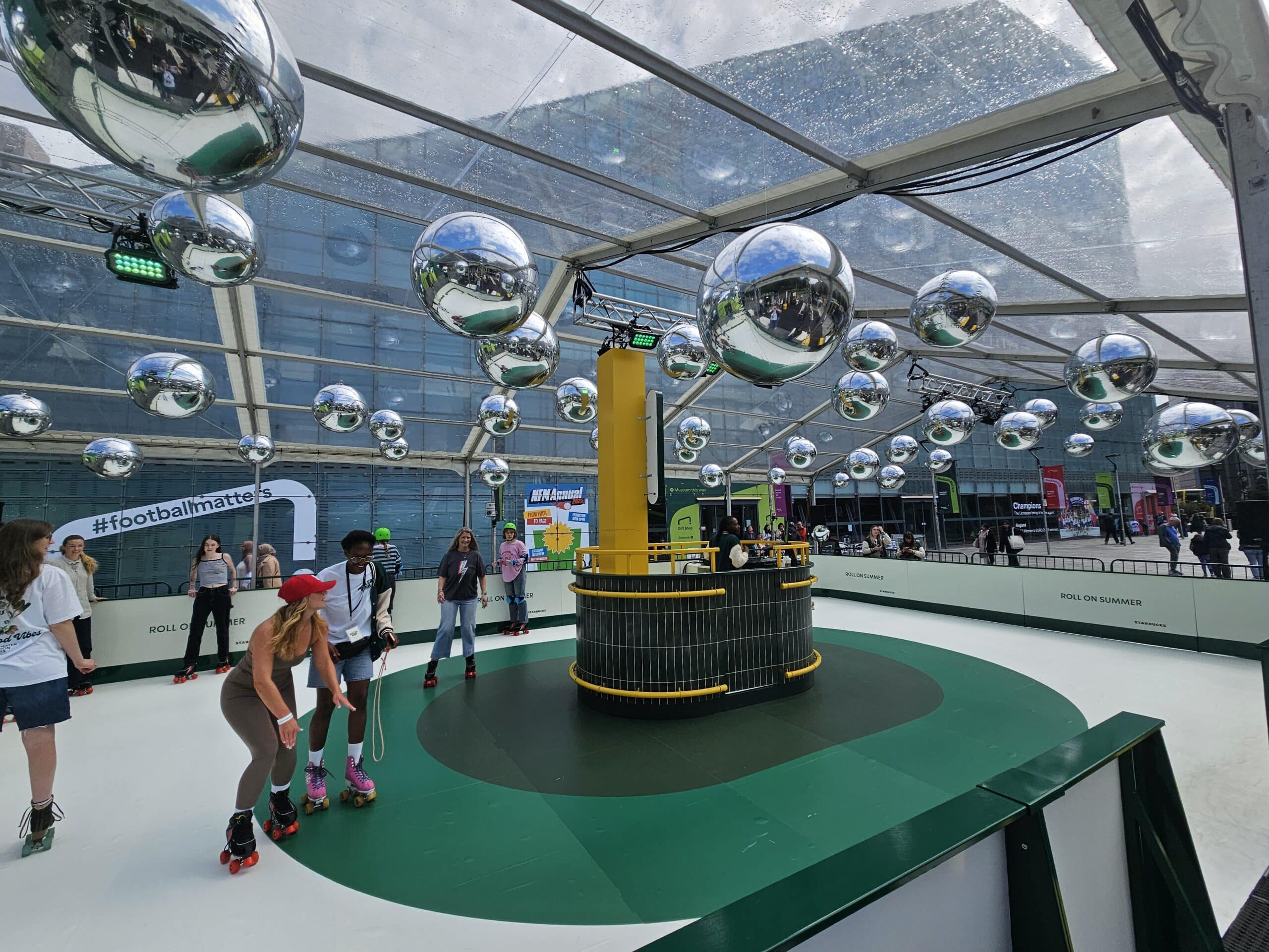 Corporate Roller Rink Hire Indoor curling setup with curling stones and a snowy, decorated environment with trees.