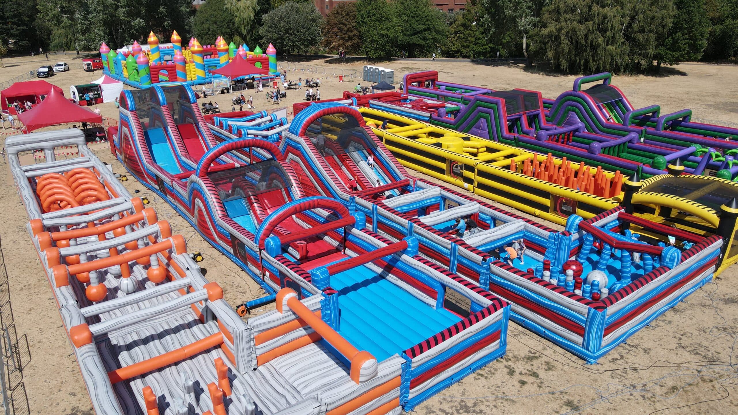 Labyrinth Challenge Tamworth 2 Colorful inflatable safari-themed obstacle course with zebra, toucan, and cartoon animal designs.