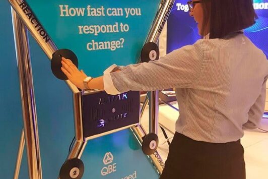 A woman uses a Batak reaction wall with the text, “How fast can you respond to change?”